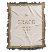 Blanket with 'GRACE NEVER FAILS ME' text on a white background