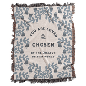 Blanket with blue floral patterns and motivational text on a white background