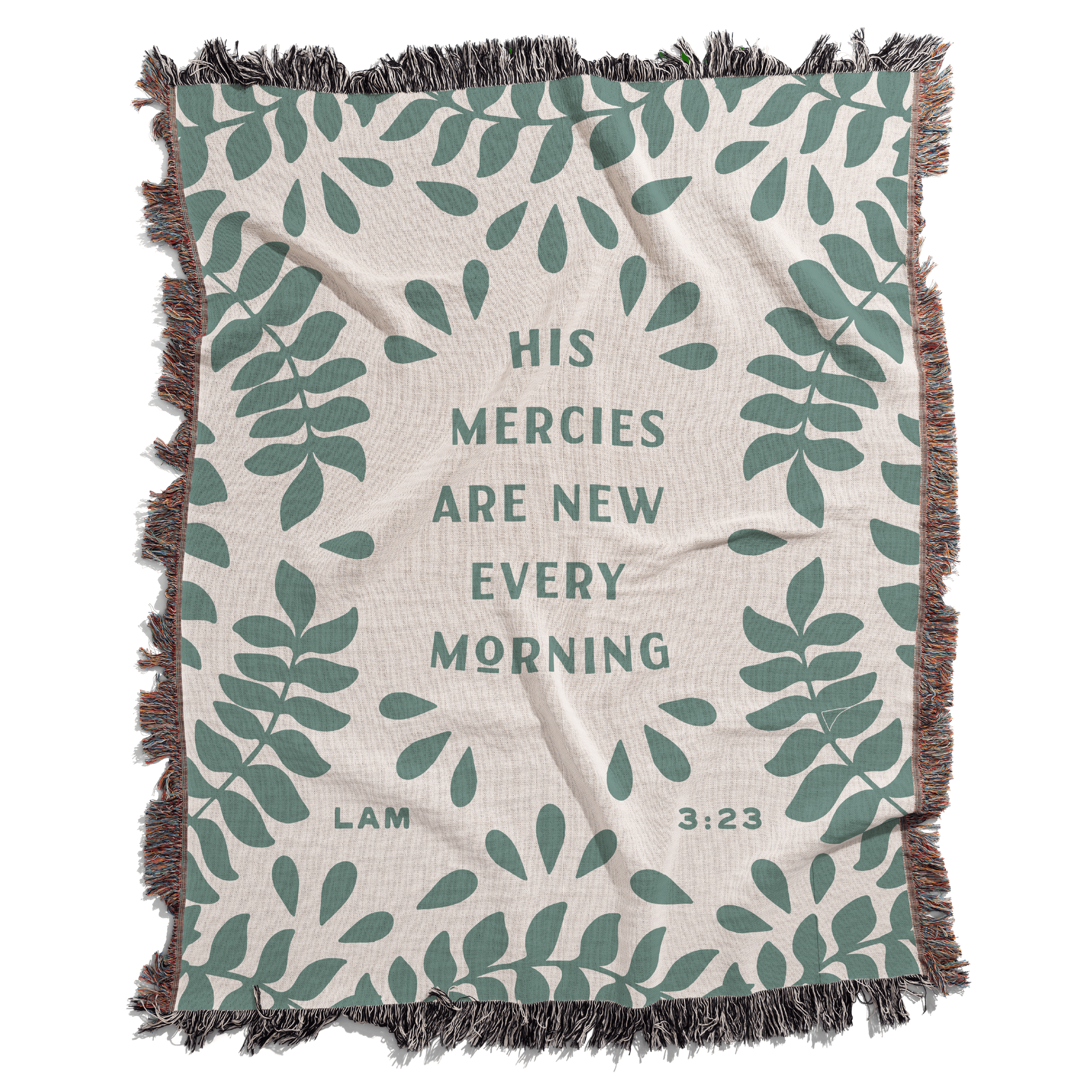 Blanket with leaf pattern and text 'His mercies are new every morning' on a white background