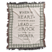 Blanket with plaid pattern and motivational quote on a white background