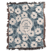 Floral patterned blanket with text on a blue background