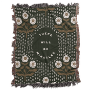 Decorative blanket with floral patterns and motivational text on a white background