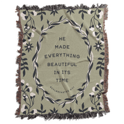 Green blanket with floral design and text 'He made everything beautiful in its time' on a white background