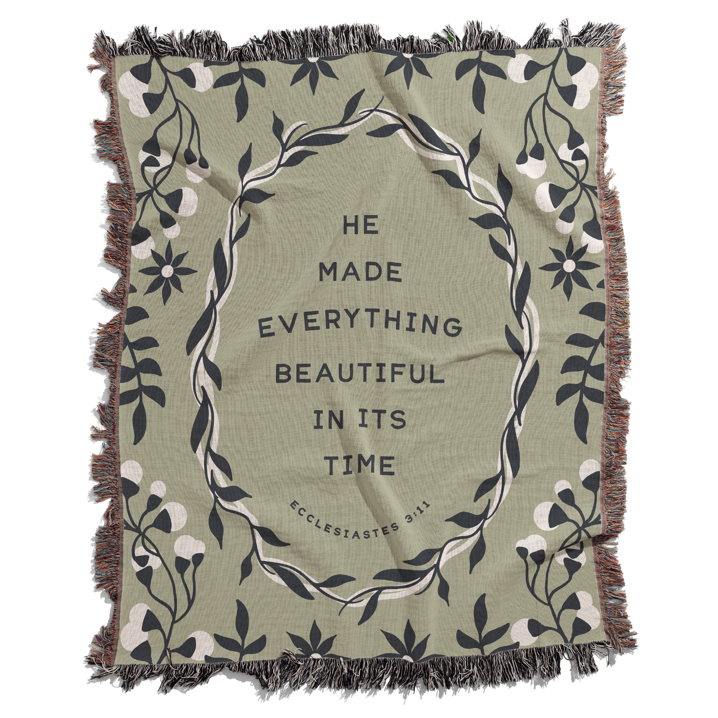 Green blanket with floral design and text 'He made everything beautiful in its time' on a white background