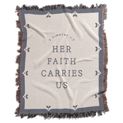 Blanket with 'Her Faith Carries Us' text and decorative border on a white background