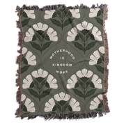 Floral patterned blanket with text 'Motherhood is Kingdom Work' on a green background