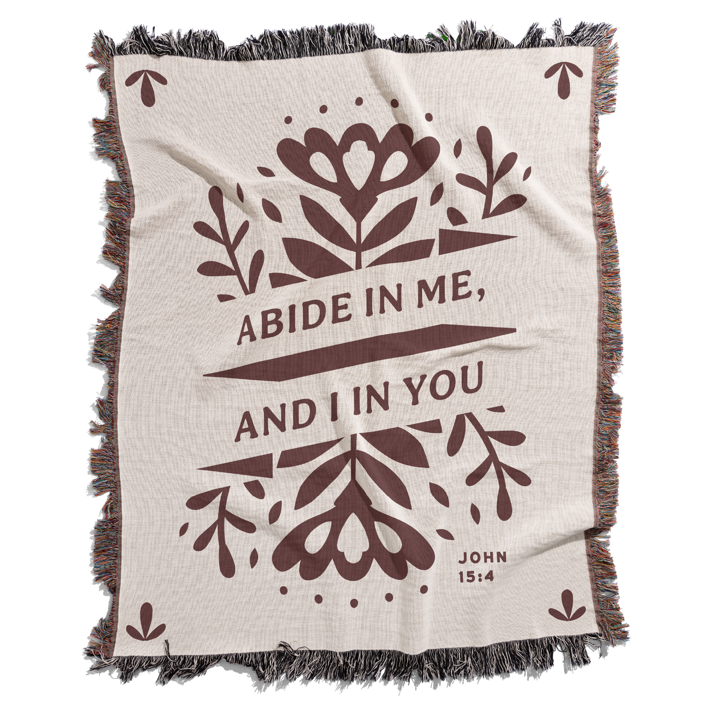 Blanket with floral design and text 'Abide in me, and I in you' on a white background