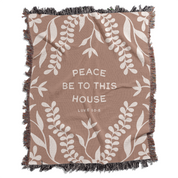 Blanket with leaf pattern and text 'Peace be to this house Luke 10:5' on a white background