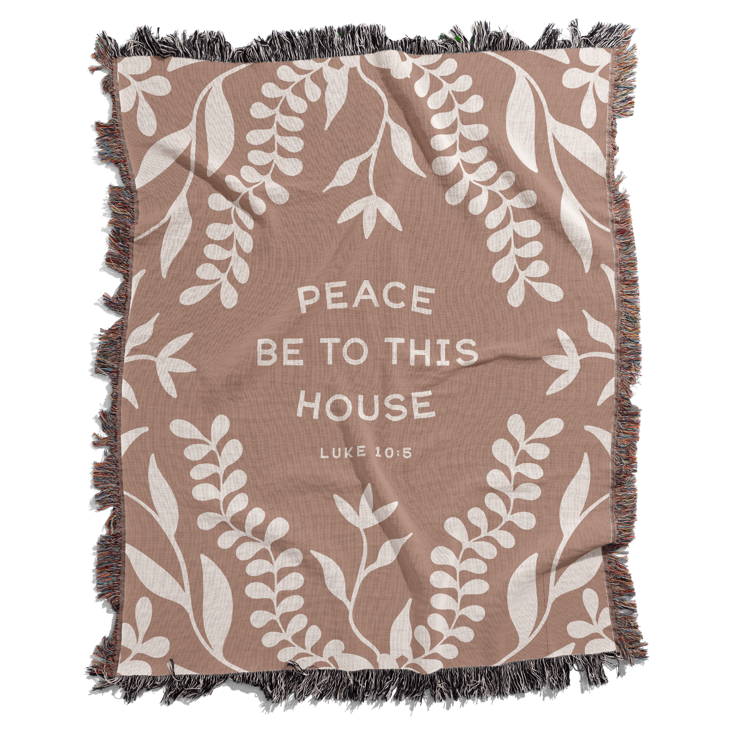 Blanket with leaf pattern and text 'Peace be to this house Luke 10:5' on a white background