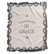 Blanket with 'Anchored in Grace' text on a white background