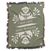 Green blanket with white floral design and text 'I Was Lost Now I'm Found' on a white background
