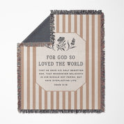 Striped blanket with text and floral design on a white background