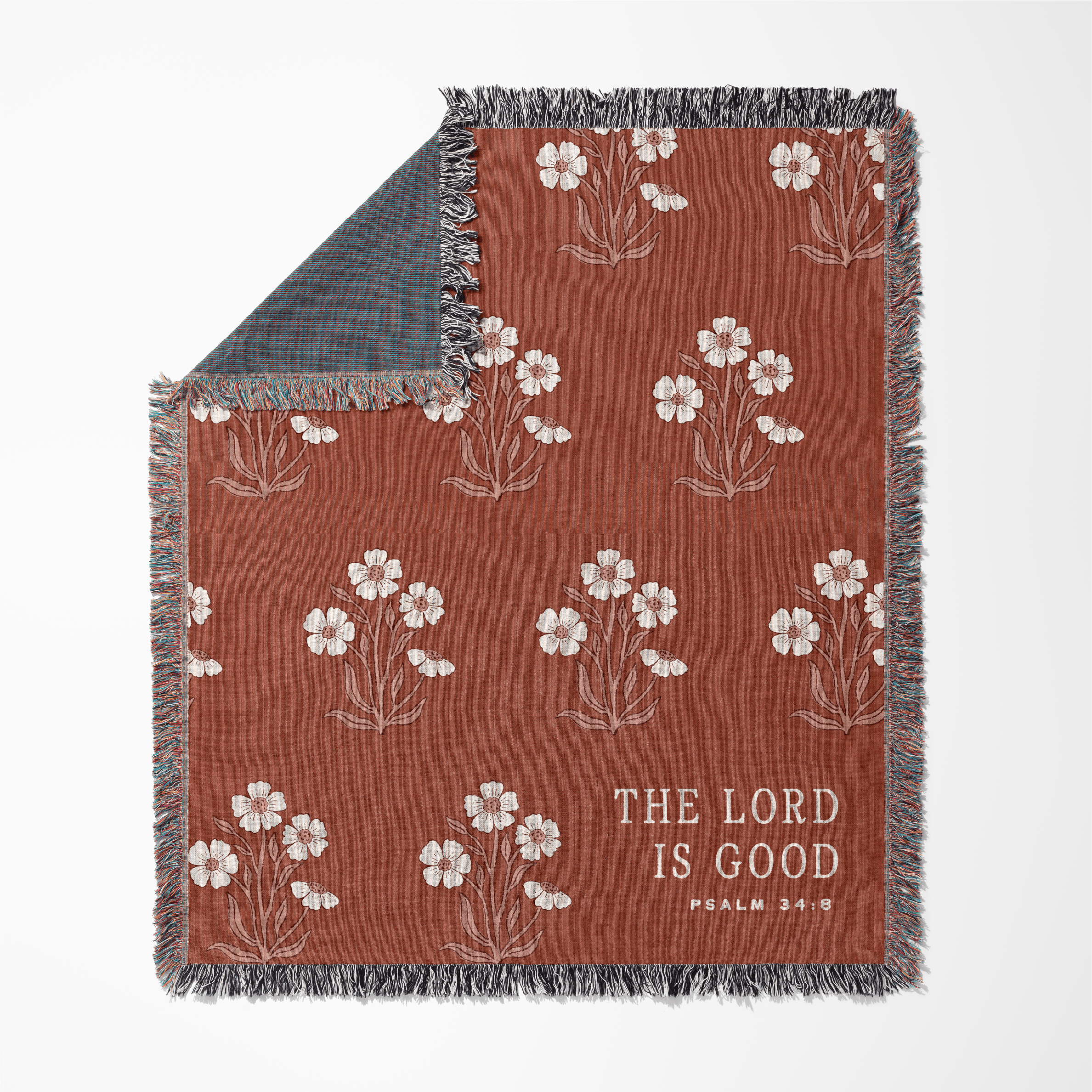 Floral patterned blanket with 'The Lord is Good' text on a white background