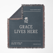 Gray blanket with text and floral design on a white background