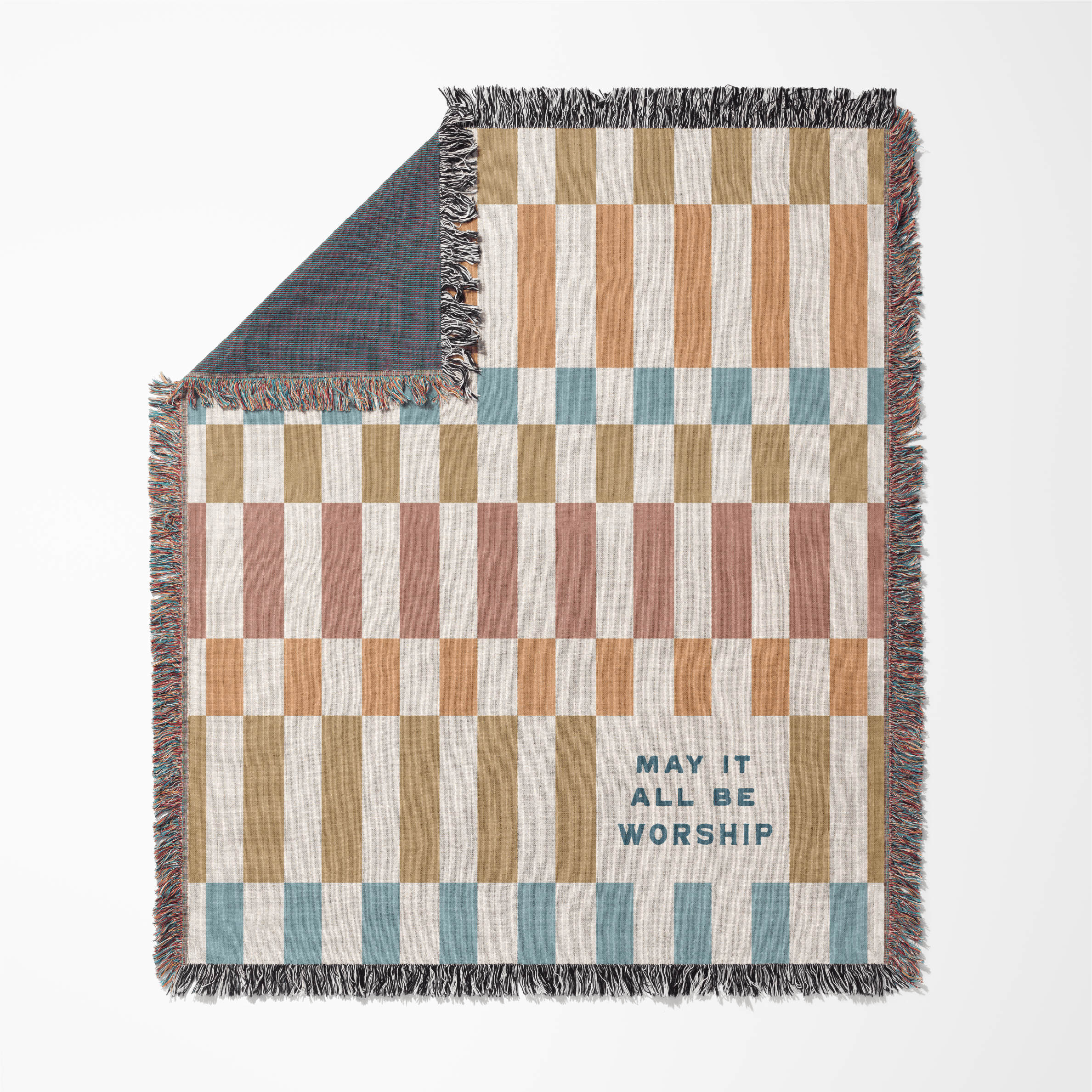 Checkered blanket with text 'May it all be worship' on a white background