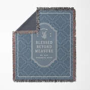 Decorative throw blanket with text and pattern on a white background