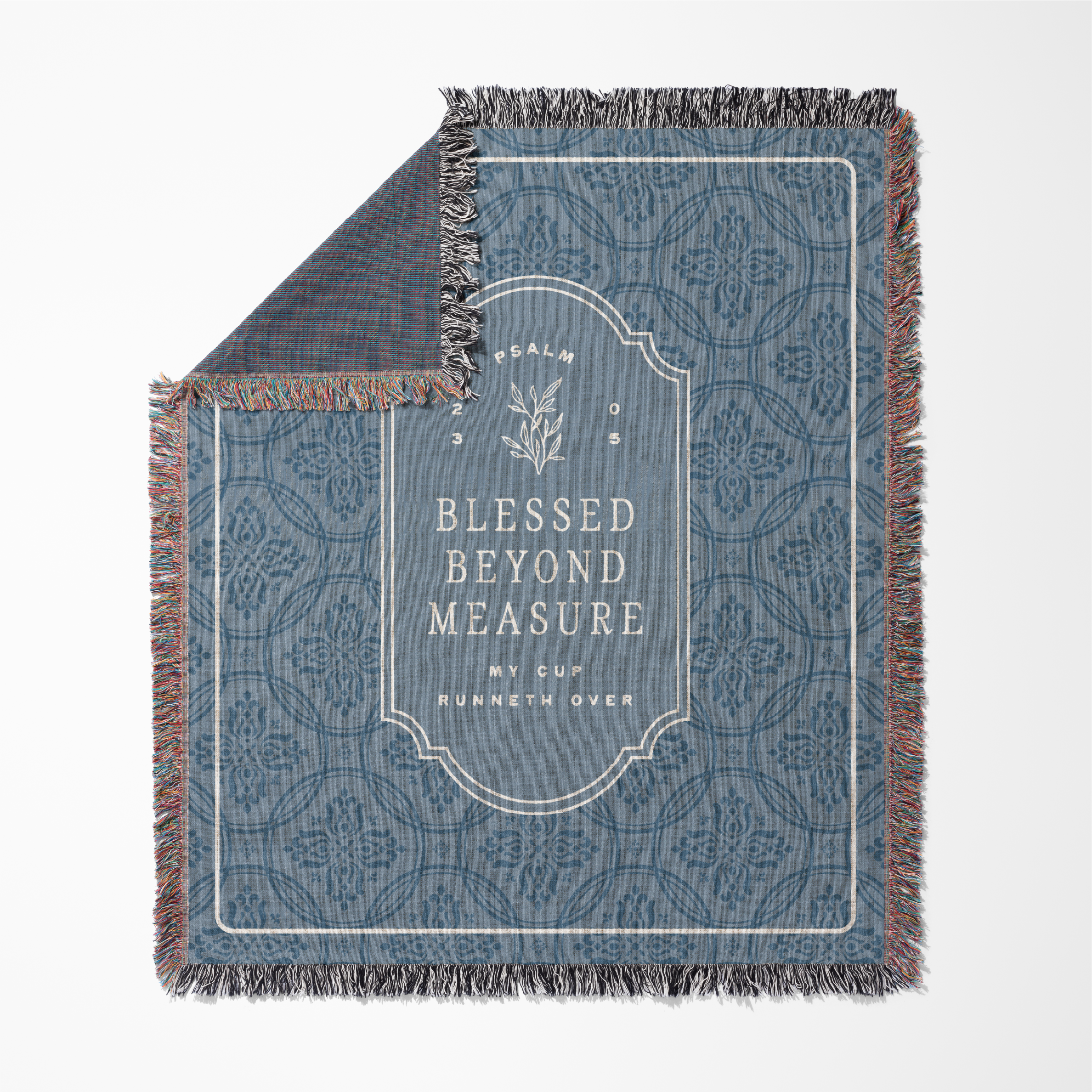 Decorative throw blanket with text and pattern on a white background