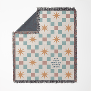 Checkered blanket with star patterns and text on a white background