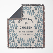 Blanket with text 'You are loved and chosen by the creator of this world' and leaf pattern