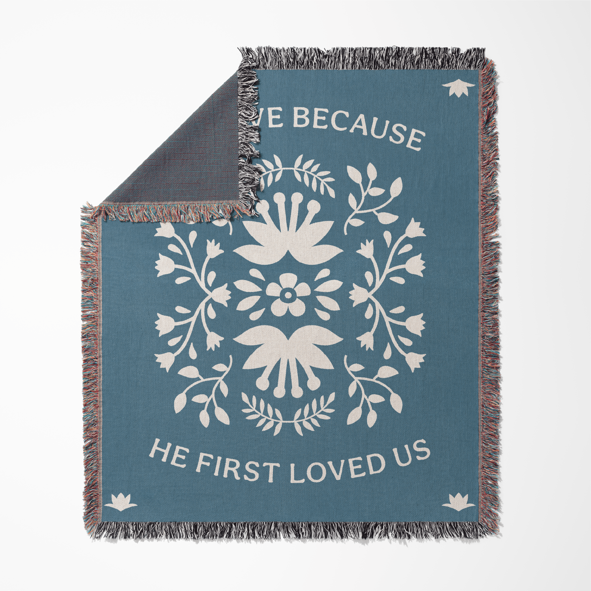 Blue blanket with white floral design and text on a white background