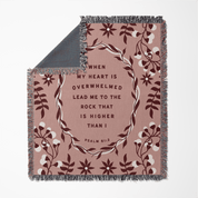 Floral-patterned blanket with inspirational quote on a white background
