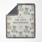 Floral patterned blanket with text 'For we are God's Masterpiece Eph 2:10' on a white background