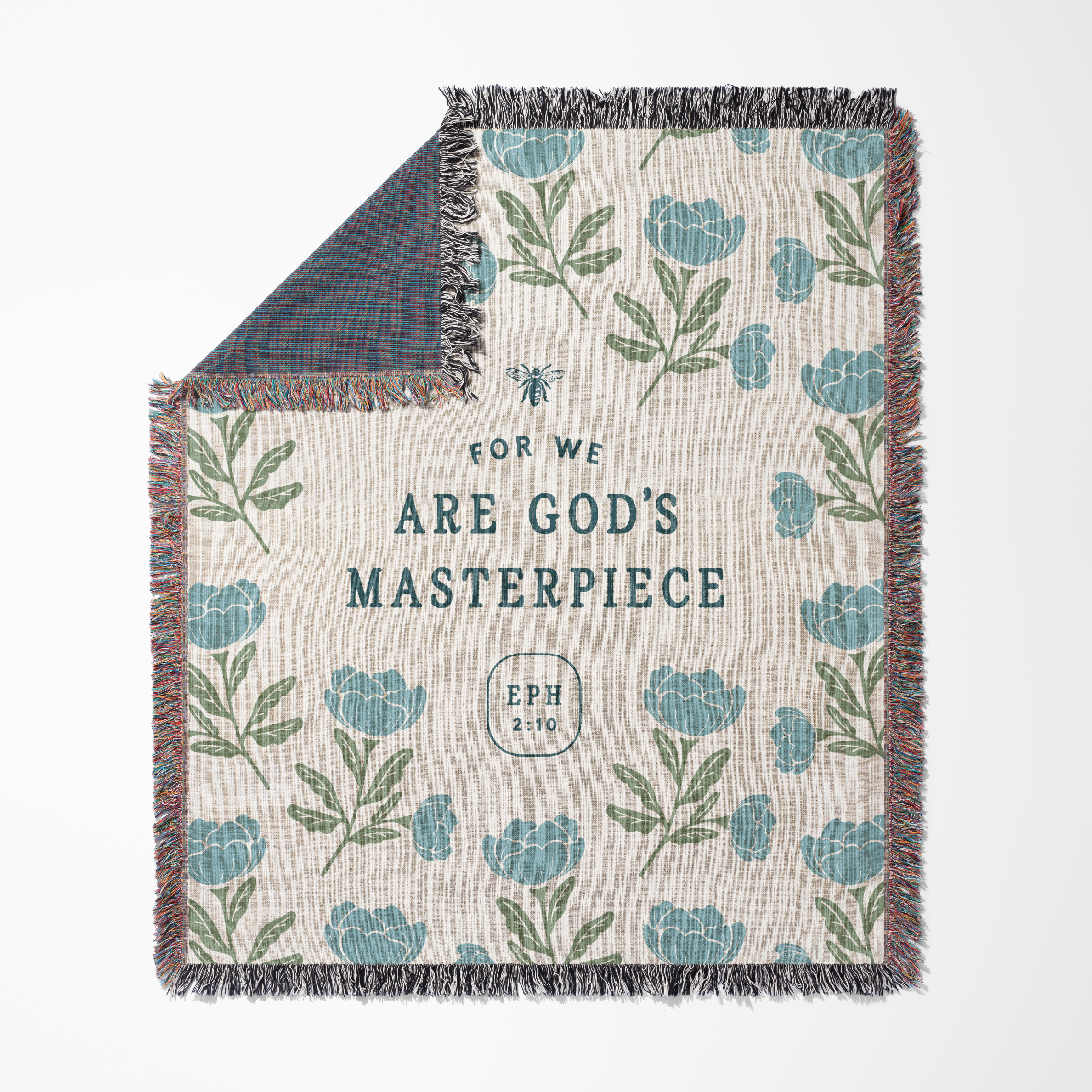 Floral patterned blanket with text 'For we are God's Masterpiece Eph 2:10' on a white background