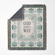 Decorative throw blanket with text and patterns on a white background