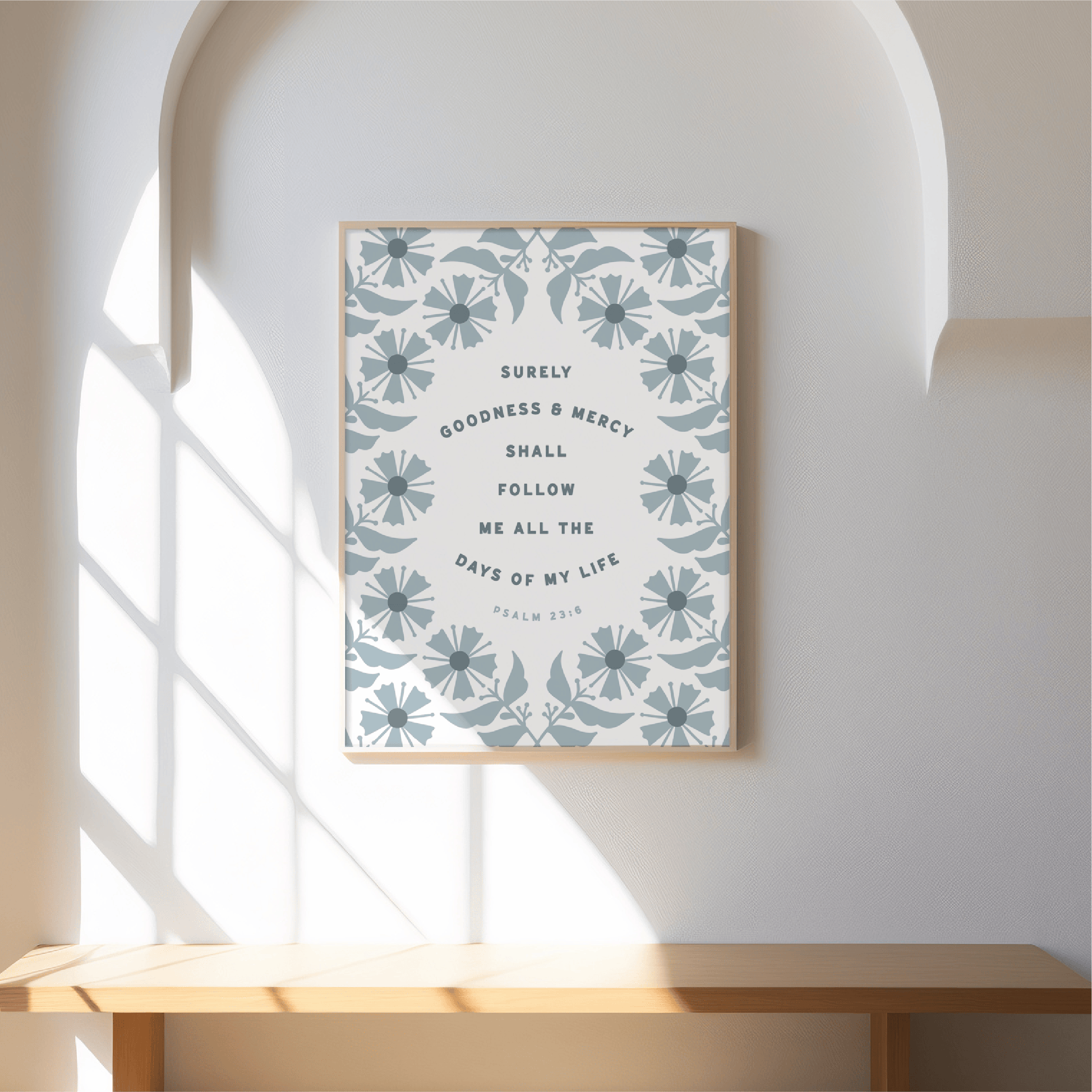 Framed artwork with floral pattern and text on a wall