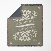 Green blanket with white floral designs and text on a white background