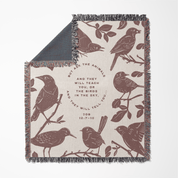 Blanket with bird pattern and text on a white background