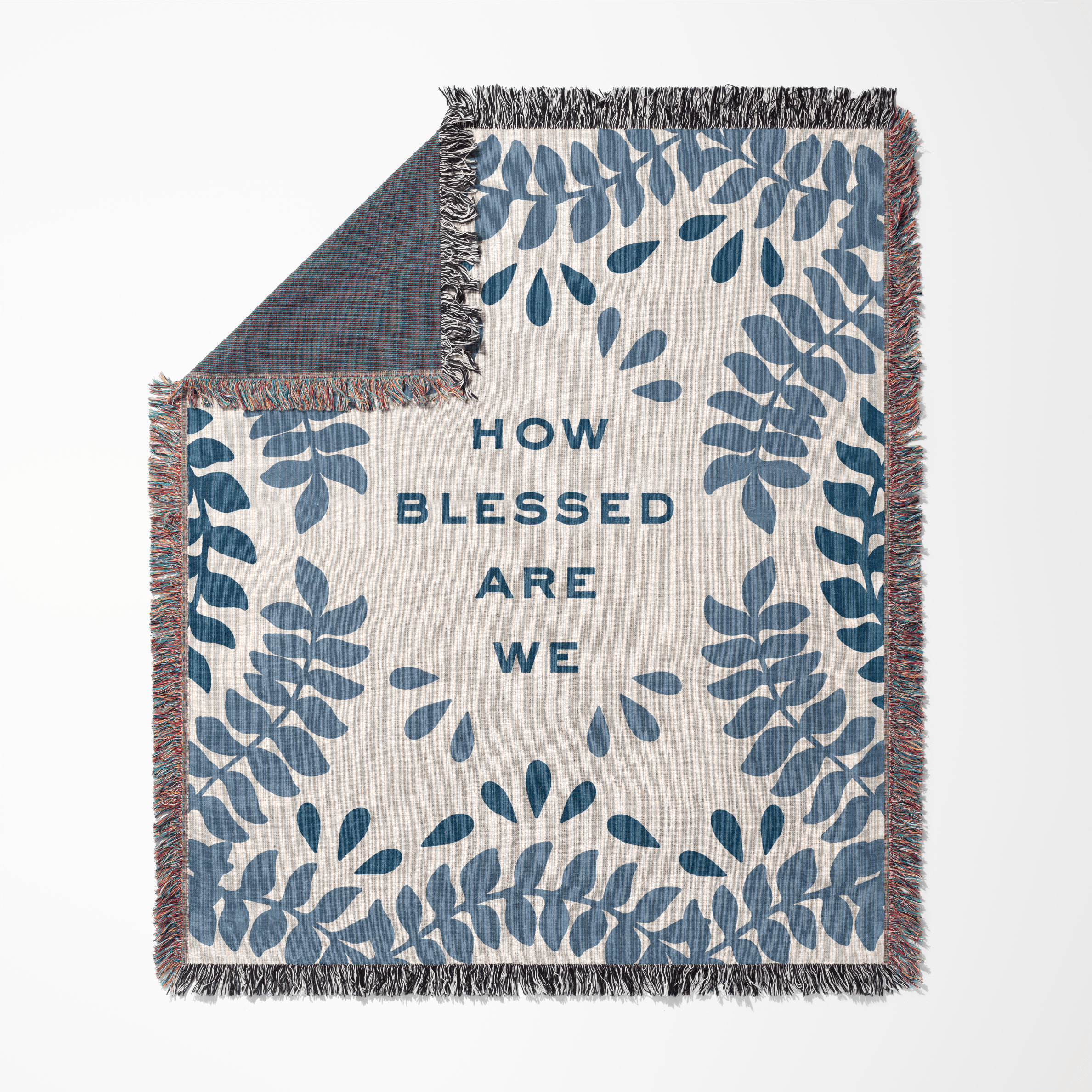 Blanket with blue leaf pattern and 'How Blessed Are We' text on a white background