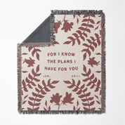 Blanket with leaf pattern and text 'For I know the plans I have for you' on a white background