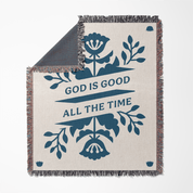 Blanket with floral design and 'God is Good All the Time' text on a white background