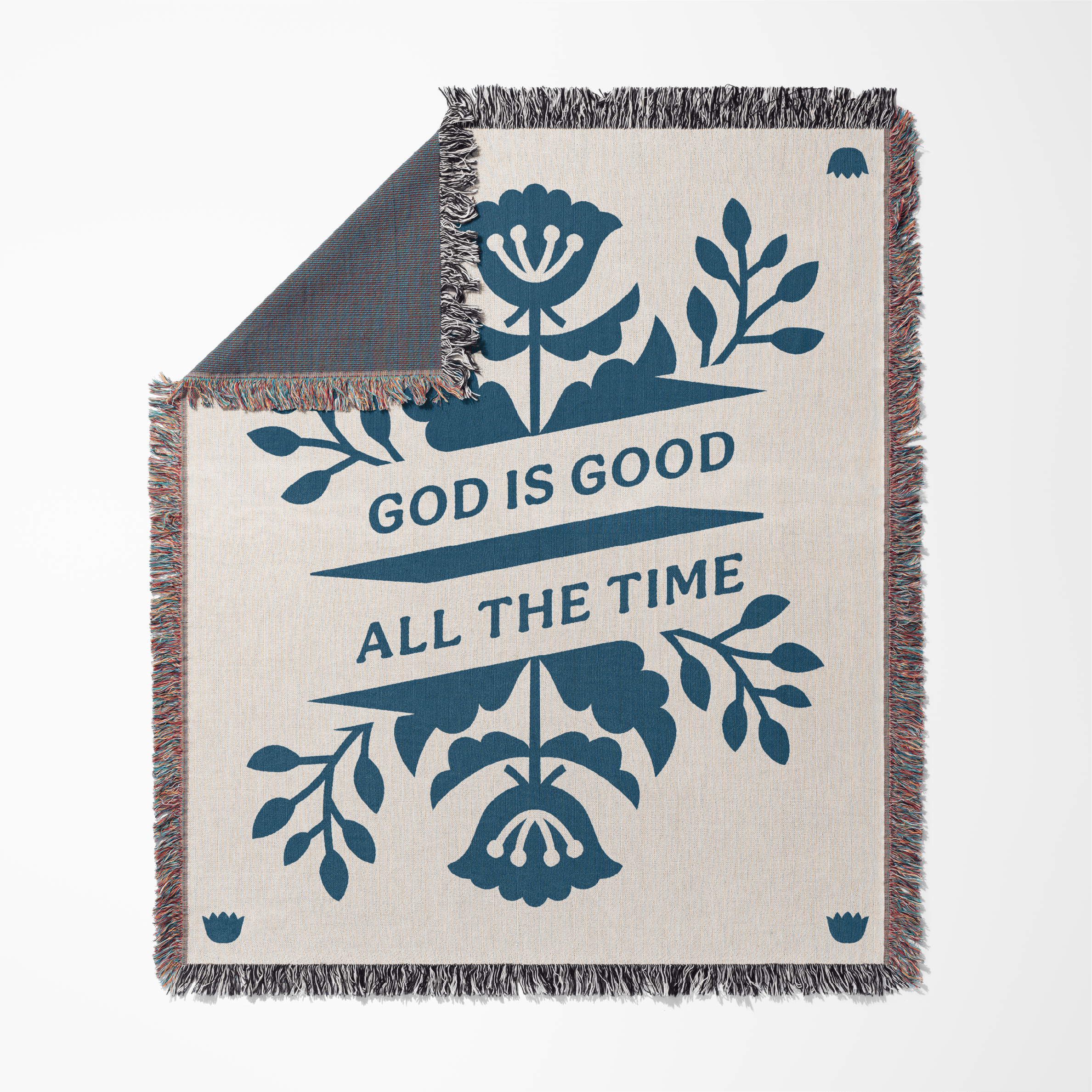 Blanket with floral design and 'God is Good All the Time' text on a white background