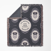 Decorative blanket with floral patterns and text on a gray background