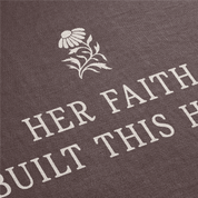 Text 'HER FAITH BUILT THIS HOUSE' with a floral design on a brown background
