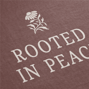 Text 'Rooted in Peace' with a flower design on a brown background