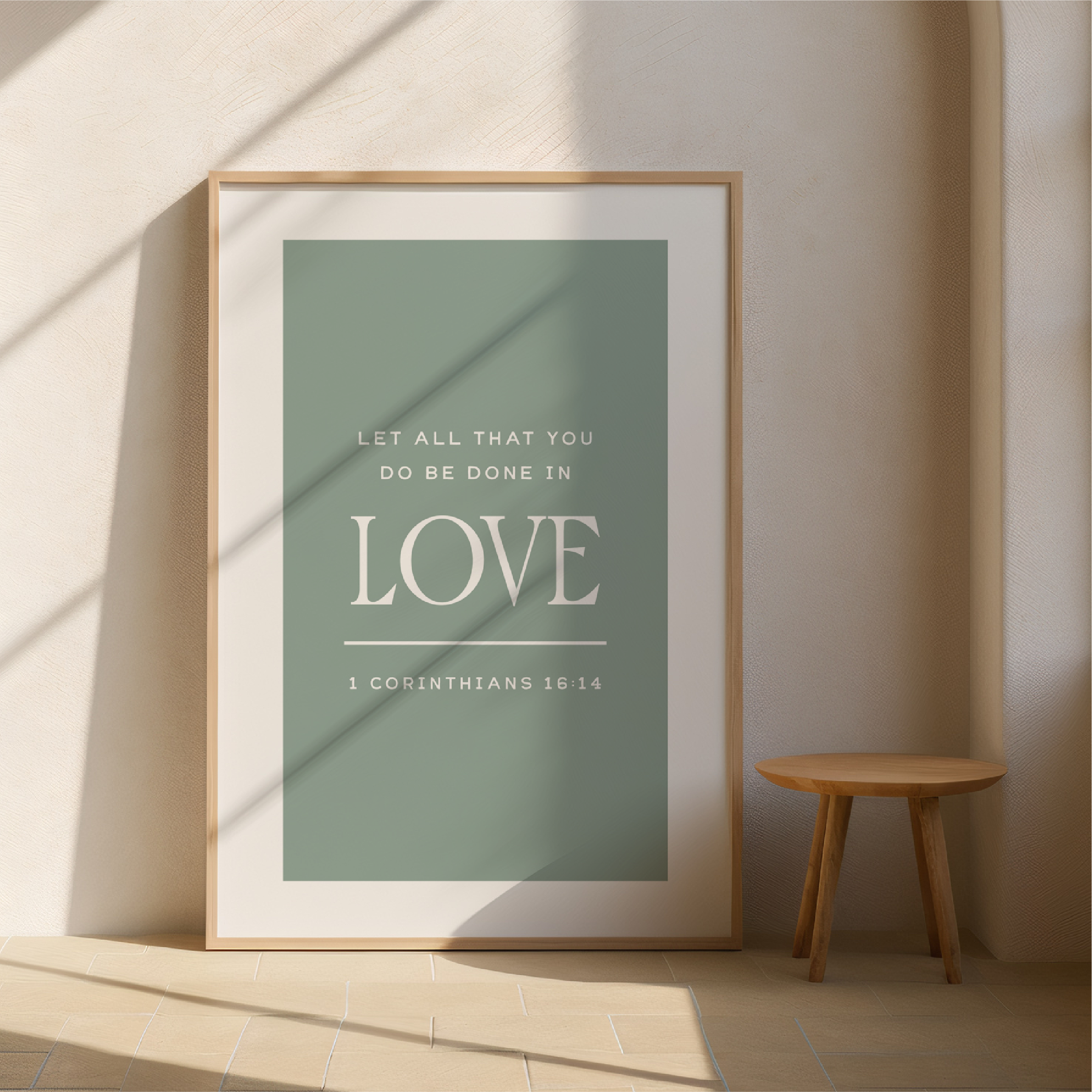 Framed poster with motivational quote on a wall with a wooden stool.