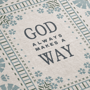 Textile with 'God always makes a way' quote and decorative border