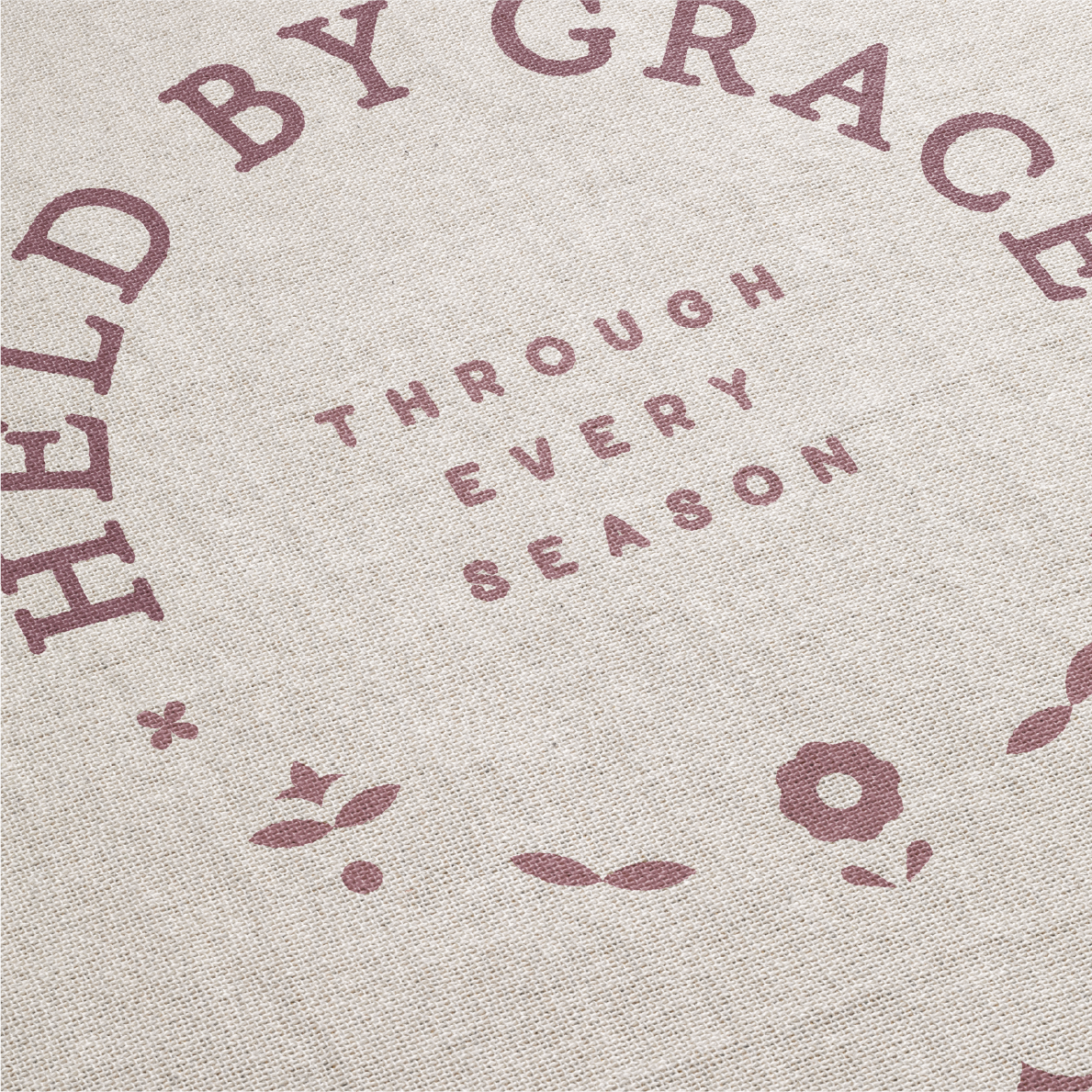 Text 'HELD BY GRACE THROUGH EVERY SEASON' with floral designs on a textured background