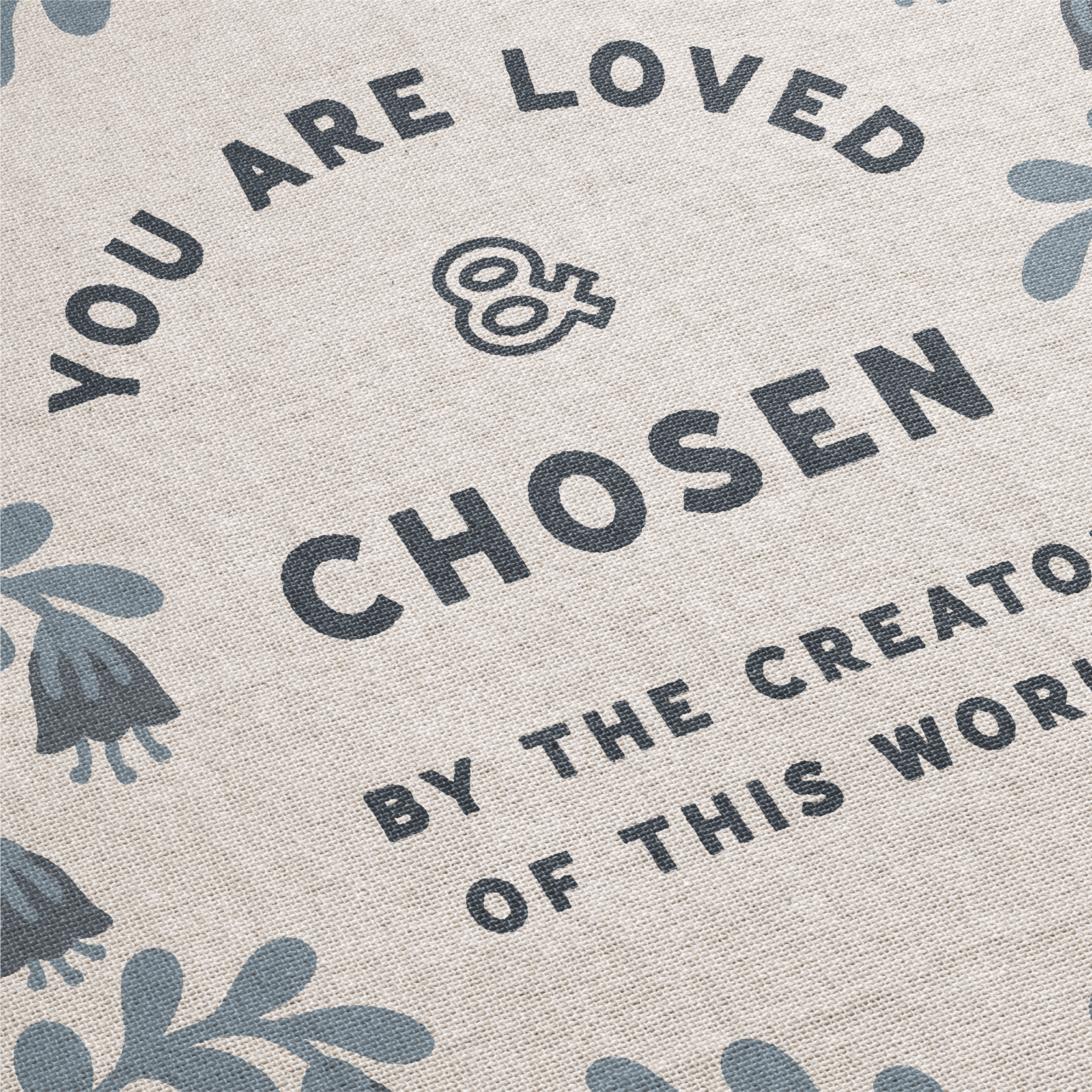Text on a fabric background with floral patterns, reading 'You are loved & chosen by the creator of this world'.