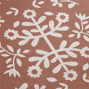 White floral and leaf pattern on a brown background