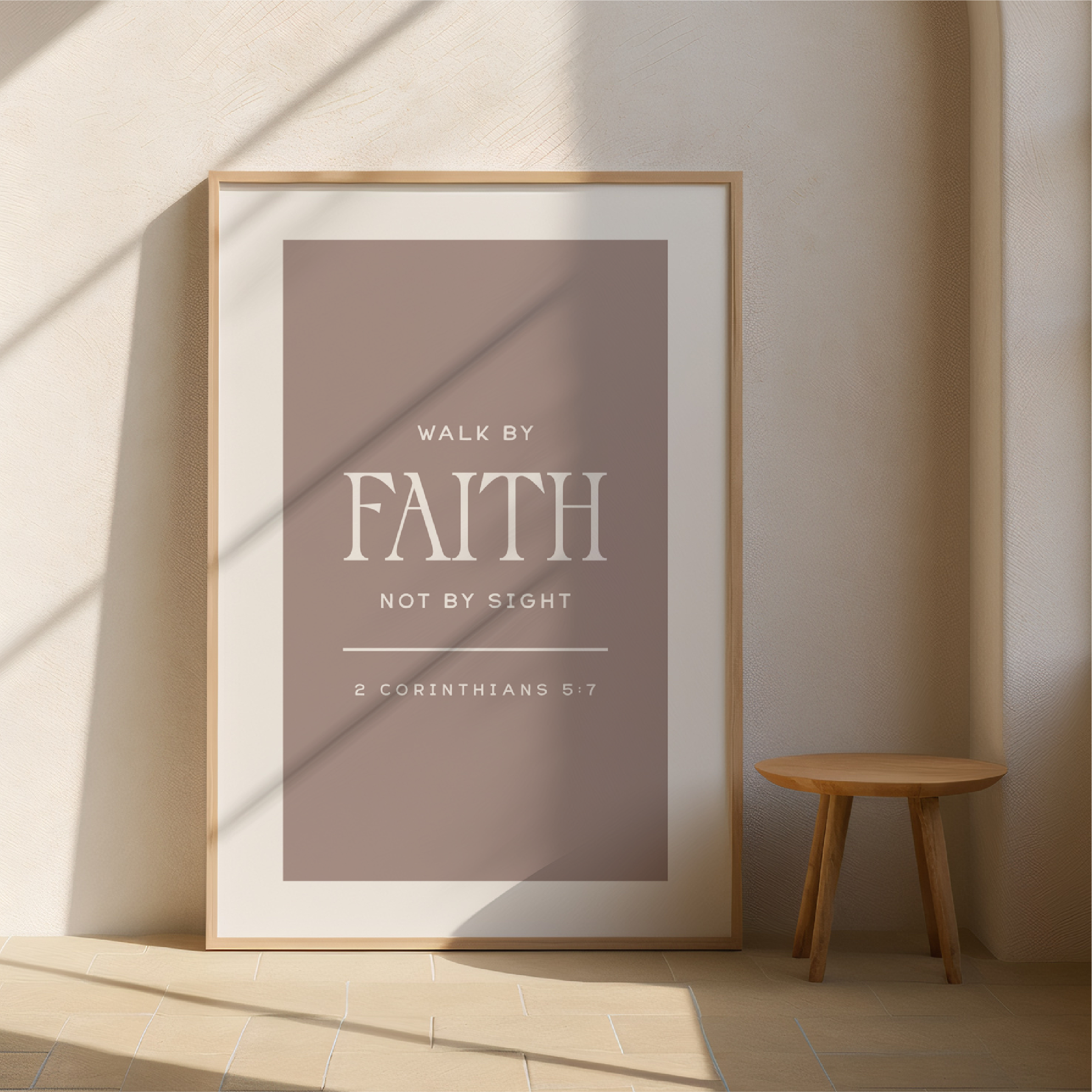 Framed poster with 'Walk by Faith, Not by Sight' quote on a wall with a wooden stool.