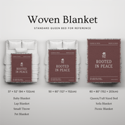Woven blanket with 'Rooted in Peace' branding displayed on a bed for reference.