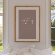 Framed poster with 'Walk by Faith, Not by Sight' quote on a wall in a home setting.
