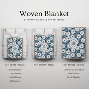 Woven blanket with floral pattern displayed on a bed with size reference labels.