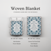 Woven blanket with floral pattern and text, shown on a bed for reference, on a light gray background.