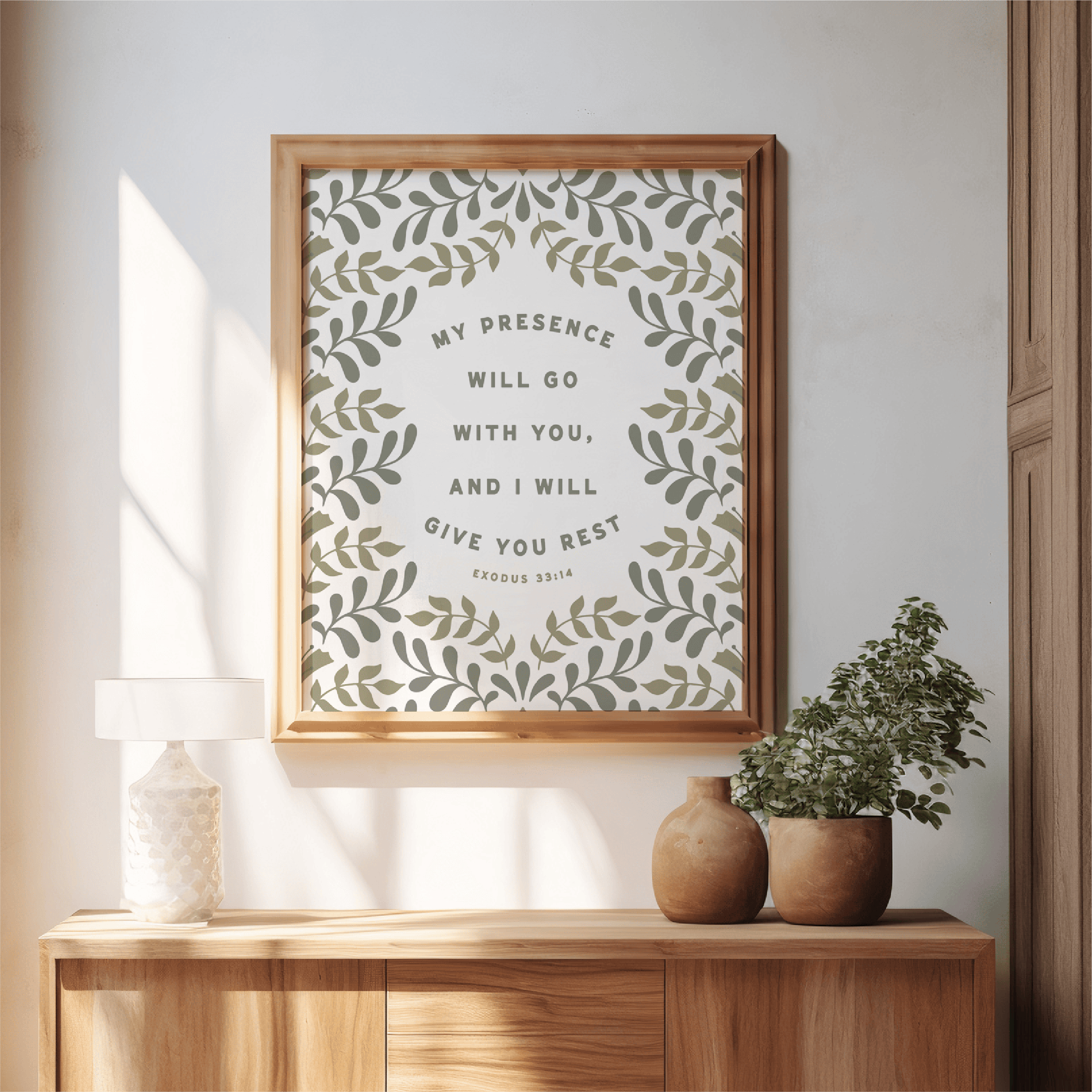 Framed artwork with motivational quote on a wall above a wooden console table.