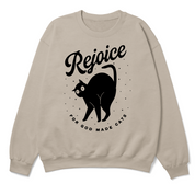 Beige sweatshirt with black cat graphic and 'Rejoice for God made cats' text on a white background